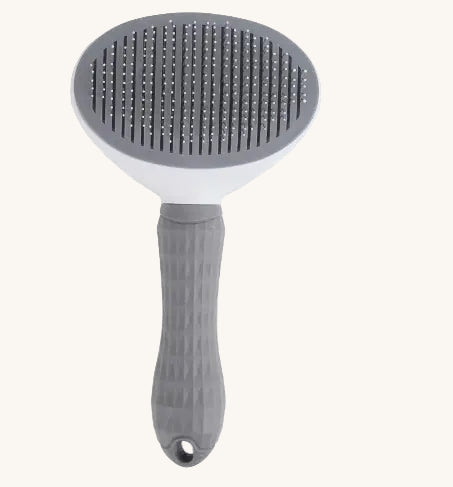 Pet grooming brush with gray bristle head and handle on a white background