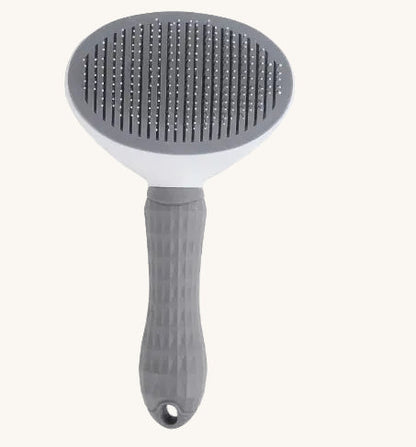 Pet grooming brush with gray bristle head and handle on a white background